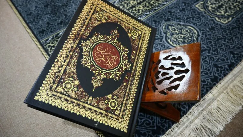Open Quran on a wooden rehal in soft window light - online Quran classes for kids